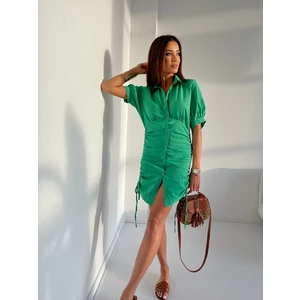 Green shirt dress with ruffles on the hips