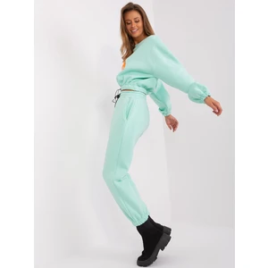 Mint and fluoroorange tracksuit with letter A