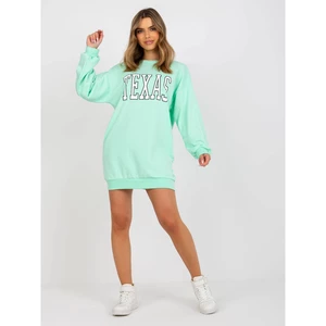 Light green oversized sweatshirt with a print