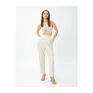 Koton Silky-textured pants with elastic waist and pockets.